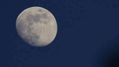 Low angle view of moon against clear sky at night