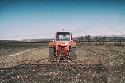 Abandoned truck on field against sky