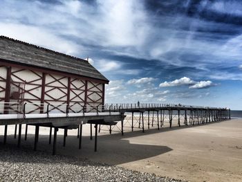 Built structure on beach against sky