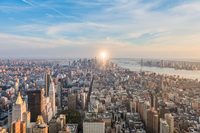 Buildings against sky during sunset at manhattan