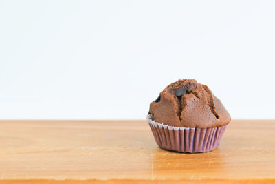 Close-up of cupcakes on table against white background