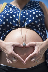 Midsection of woman wearing mask