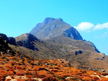 Low angle view of rocky mountains against sky