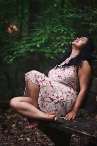 Midsection of woman sitting outdoors