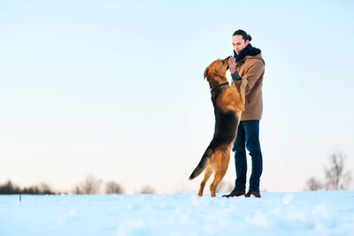 Full length of a dog standing on snow