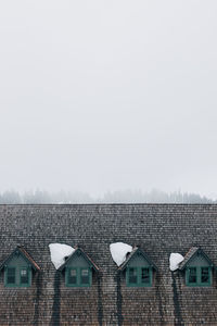 High section of house against clear sky in winter