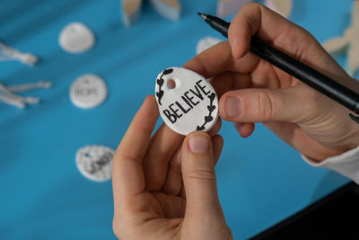 Cropped hand of person holding pills