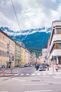 City street by buildings against sky