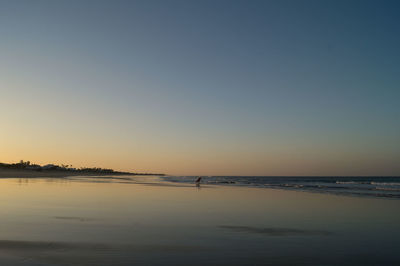 Scenic view of sea against clear sky during sunset