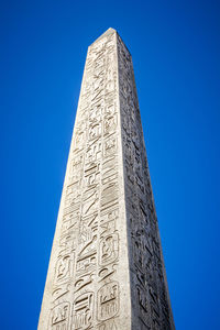 Low angle view of monument against blue sky