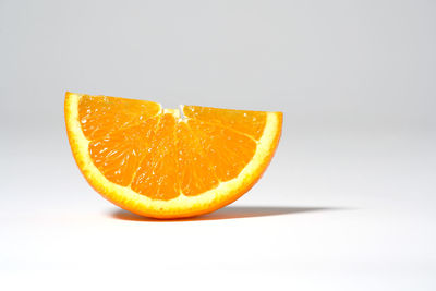 Close-up of orange fruit against white background