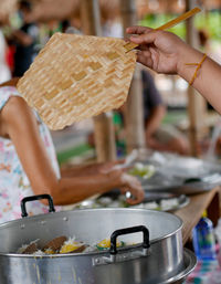 Close-up of person preparing food in kitchen at home