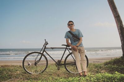 Portrait of man with bicycle on land