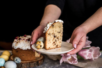 Midsection of woman holding ice cream in plate