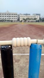 Close-up of metallic structure on beach against sky