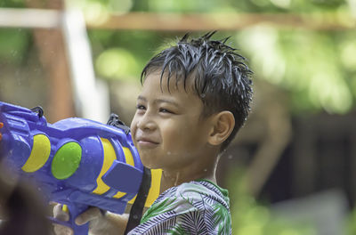 Boy playing with squirt gun