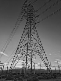 Low angle view of electricity pylon against sky