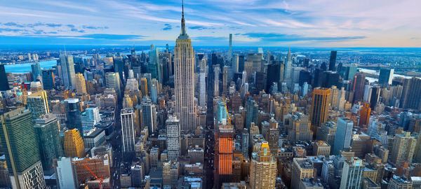 Aerial view of city buildings against cloudy sky,new york city