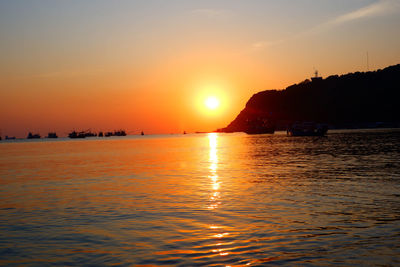 Scenic view of sea against romantic sky at sunset