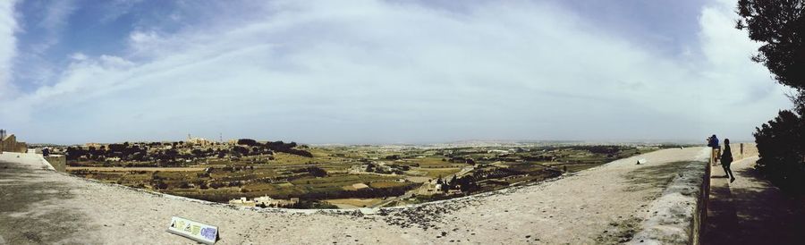 Scenic view of landscape against cloudy sky
