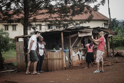 People standing outside house