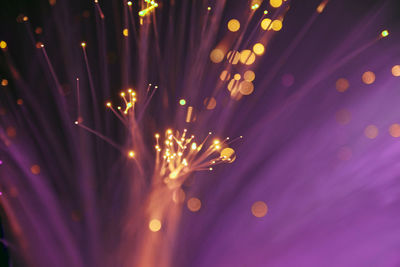 Close-up of illuminated lighting equipment against black background