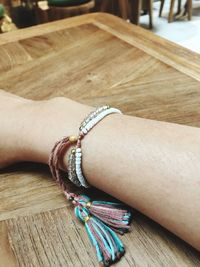 High angle view of woman hand on wooden table