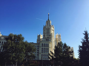 Low angle view of buildings against blue sky