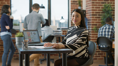 Young woman using laptop at office