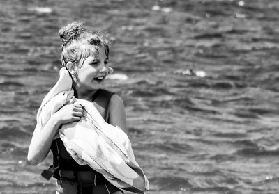 Portrait of happy girl standing in sea