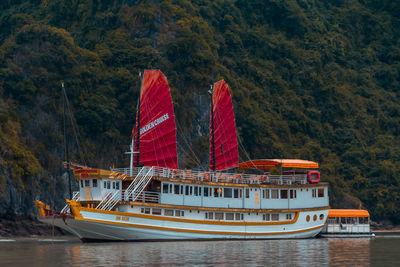 Boat sailing on lake against trees