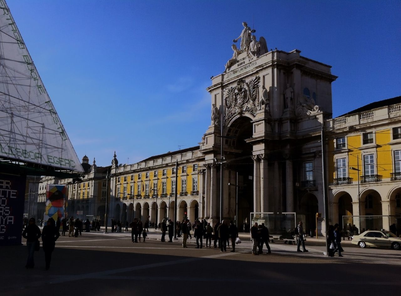 architecture, built structure, building exterior, large group of people, famous place, travel destinations, tourism, city, travel, international landmark, clear sky, person, history, men, capital cities, facade, tourist, blue, city life