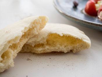 Close-up of halved pita bread on table