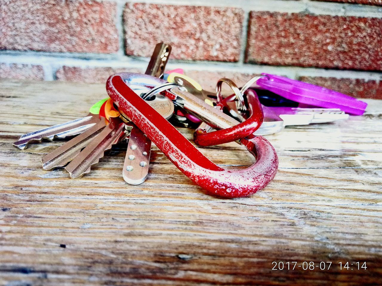 CLOSE-UP OF RED CHILI PEPPERS ON WOOD