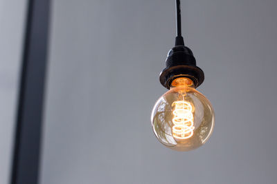Low angle view of illuminated light bulb