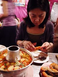 Woman eating food served in plate