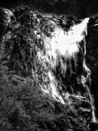 Low angle view of waterfall against sky