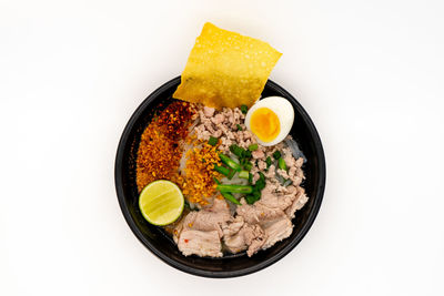 High angle view of food in bowl against white background