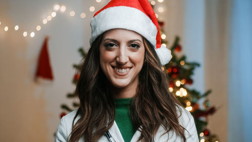 Female doctor smiles with christmas hat