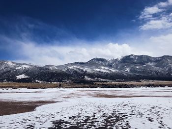 Scenic view of snowcapped mountains against sky