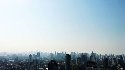 Modern buildings in city against clear sky