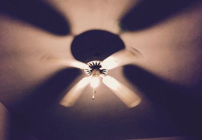 Low angle view of illuminated lighting equipment at home