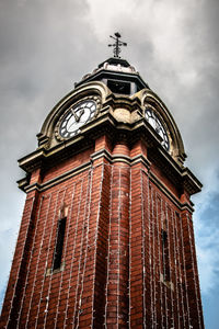 Low angle view of clock tower against sky