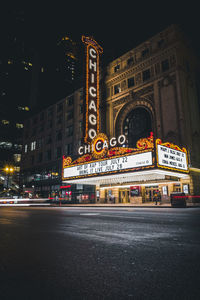 Illuminated city street and buildings at night