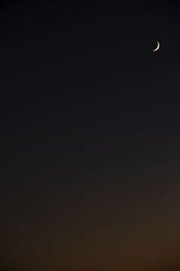 Low angle view of moon in sky at night