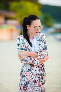 Mid adult woman wearing sunglasses standing outdoors