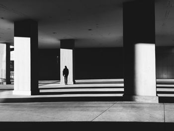 Woman walking in corridor of building