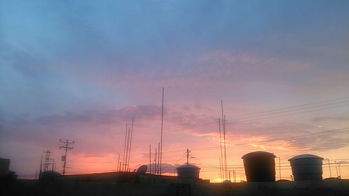 Electricity pylon against sky during sunset