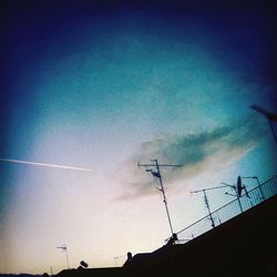 Low angle view of power lines against sky