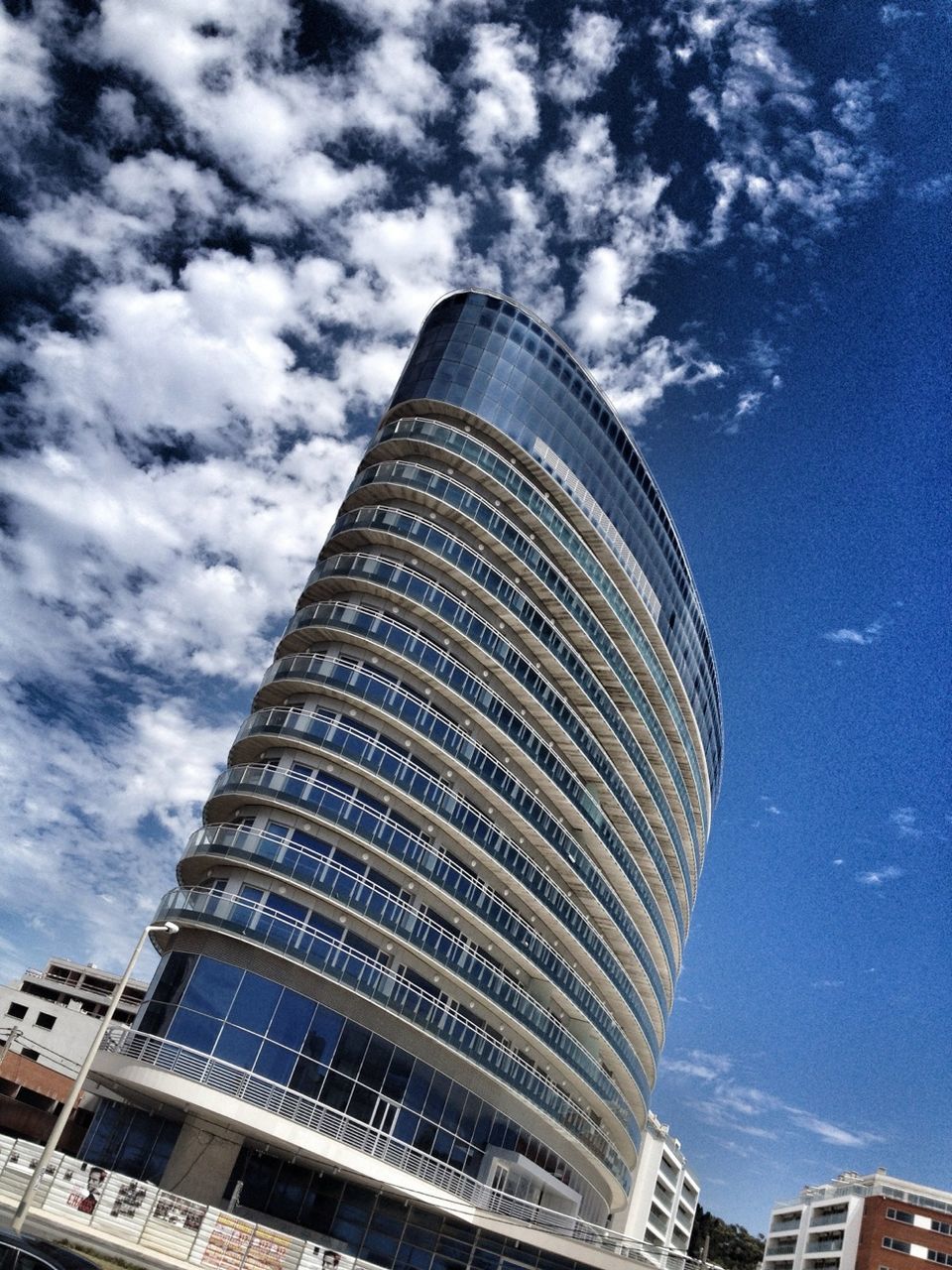 architecture, building exterior, built structure, low angle view, modern, sky, city, tall - high, skyscraper, office building, tower, cloud - sky, cloud, building, cloudy, tall, glass - material, day, outdoors, no people